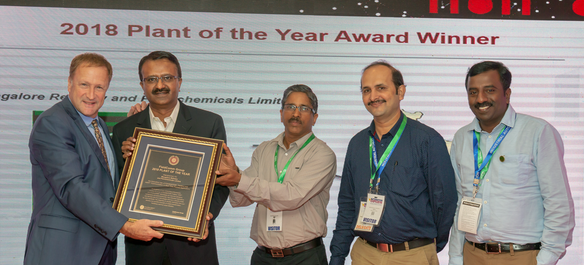 Ted Masters, President and CEO of FieldComm Group (left), presents the 2018 Plant of the Year plaque to the Mangalore Refinery and Petrochemical Limited (MRPL) team, at 2018 Automation Fair in Mumbai, India.